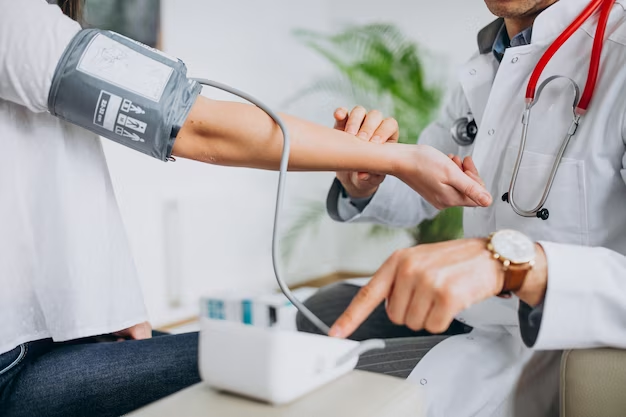 Doctor measuring patient's blood pressure with a sphygmomanometer