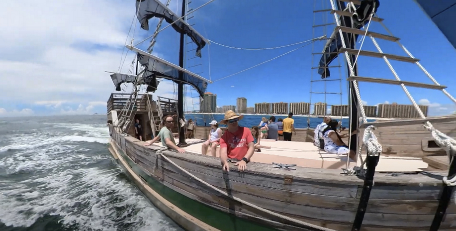 Pirate ship with tourists sailing on the sea.