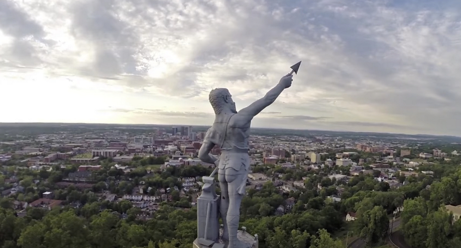 High statue overlooking a cityscape.