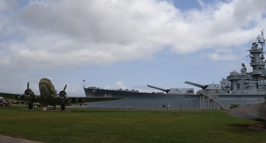 Outdoor location with a ship and an airplane.