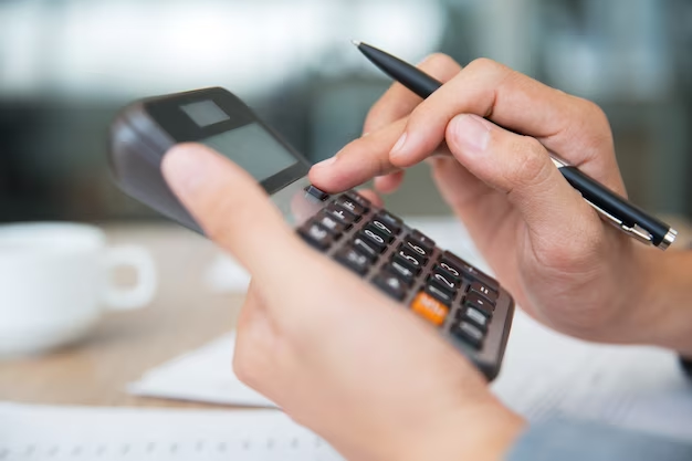 Hand using a calculator